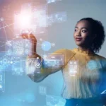 Woman interacting with holographic data and tablet, representing innovative IT consulting services.