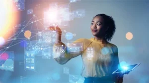 Woman interacting with holographic data and tablet, representing innovative IT consulting services.