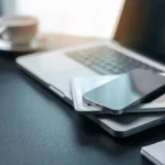 Laptop, tablet, and smartphone on a desk, representing managed IT services for multiple devices.