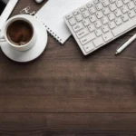 Managed Services, Desk with coffee, keyboard, mouse, tablet, and phone, representing IT consulting.